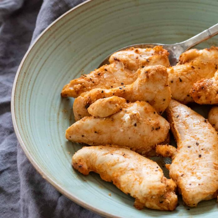 cooked chicken tenders on a green plate