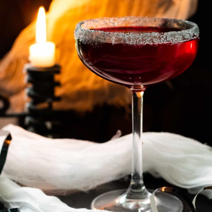 vampire margarita with a candle and cob webs in the background