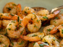 air fryed shrimp with parsley on a blue plate