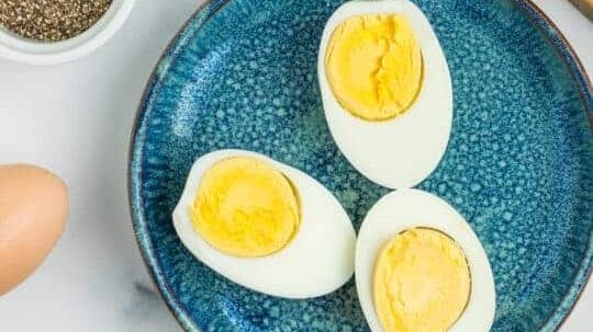 Moitiés d'œufs durs sur une assiette.