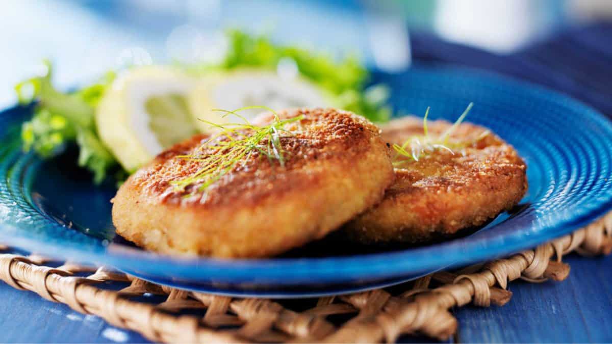 Assiette avec deux crabcakes dorés du Maryland avec garniture d'aneth