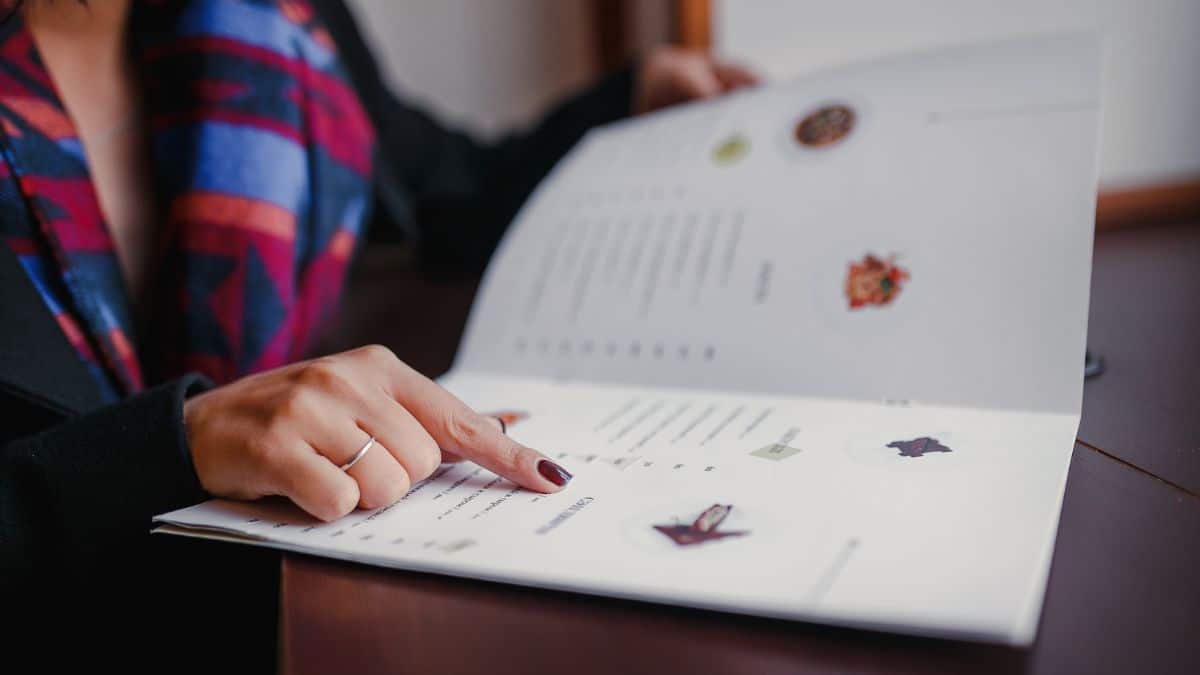 Une femme pointant un élément sur un menu.